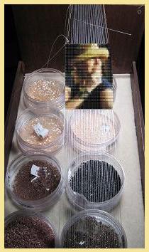 Bead-loomed portrait of Erin Simonetti still on the loom warps, above dishes of seed beads